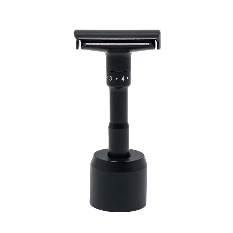 Caisson adjustable double edge safety razor upright in its stand.