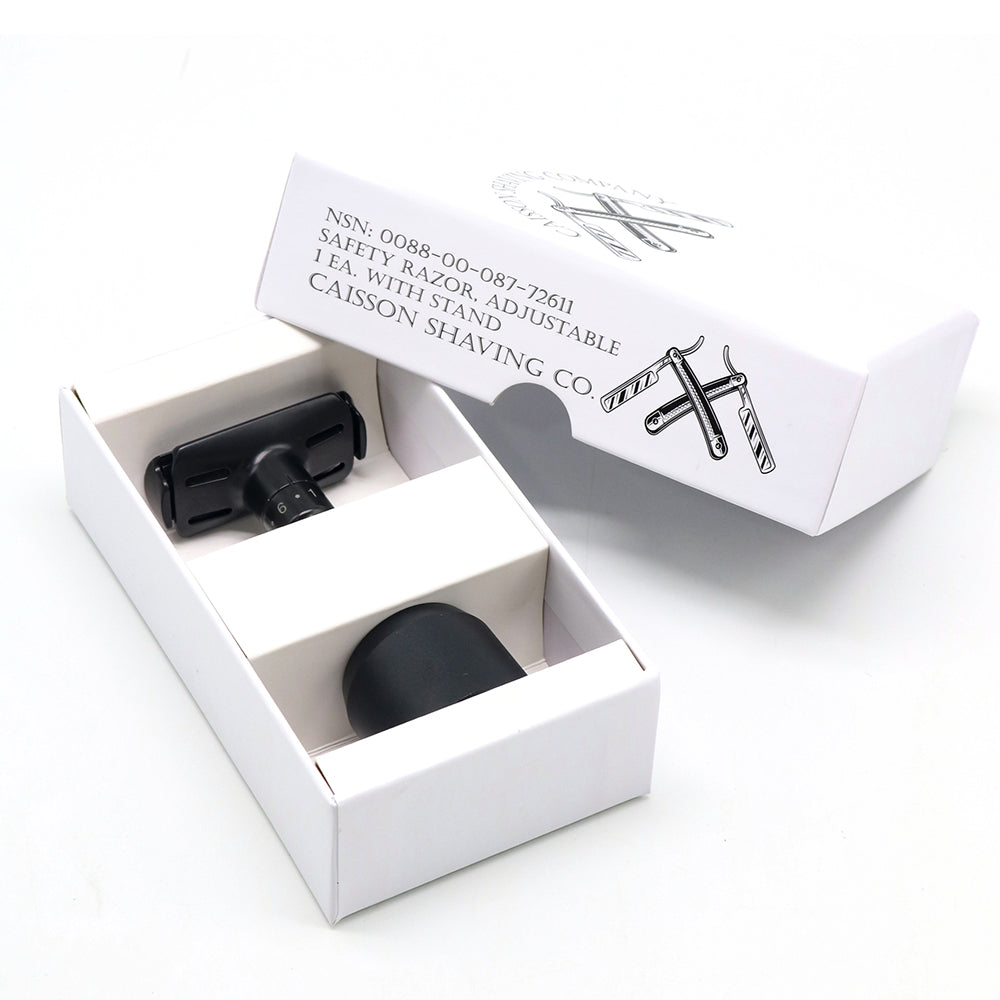 Caisson safety razor and stand in the open product box.
