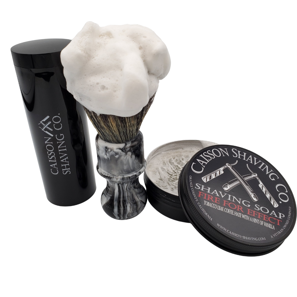 Caisson Fire For Effect shaving soap with a lathered synthetic brush and travel container.