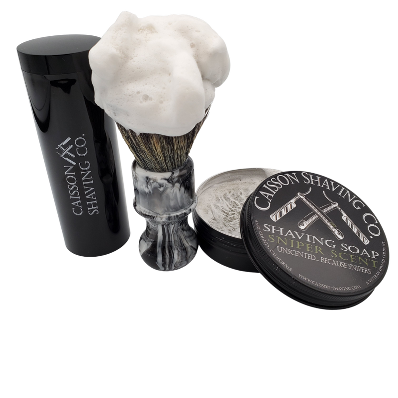 Caisson Sniper Scent shaving soap with a lathered synthetic brush and travel container.