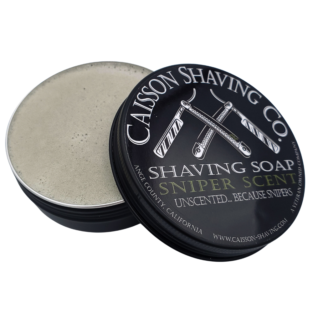 Open can of Sniper Scent shaving soap with its lid.